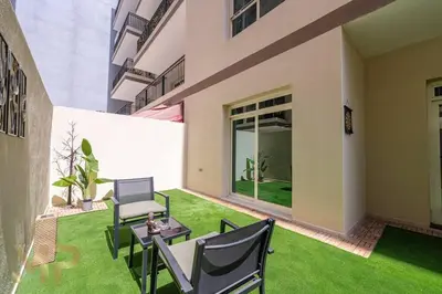 a patio with chairs and a table in a yard at Marco Polo - Experience elegant living in JVC Dubai in Dubai