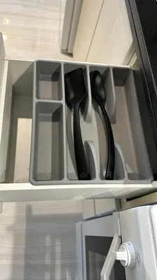 a drawer with two black handled utensils in it at Damac Hills Carson studio on Golf Course in Dubai Marina