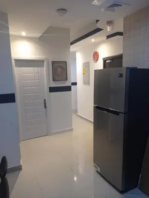 a room with a refrigerator and a white door at The Flex Partition Room Near Mall of the Emirates in Dubai