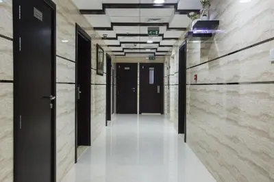an empty hallway in a building with black doors at Executive Suite Room in Barsha 1 Near MOE Metro in Dubai