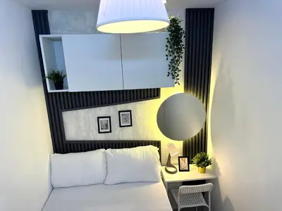 a bedroom with a white bed and a mirror at Executive Suite Room in Barsha 1 Near MOE Metro in Dubai