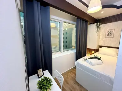 a small room with a bed and a window at Escape Partition Room in Barsha 1 Near MOE Metro in Dubai