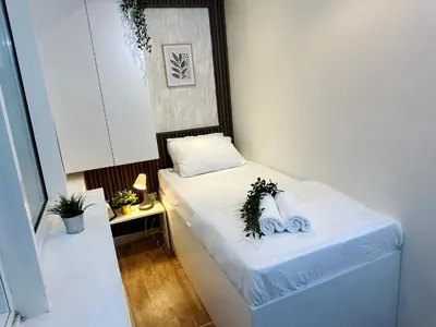 a small room with a bed with towels on it at Escape Partition Room in Barsha 1 Near MOE Metro in Dubai
