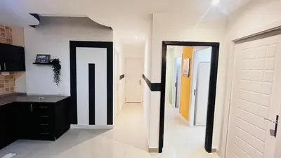 a hallway with black and white walls and doors at Escape Partition Room in Barsha 1 Near MOE Metro in Dubai