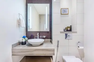 a bathroom with a sink and a mirror at DAMAC Towers by Paramount Hotels & Resorts Dubai in Dubai