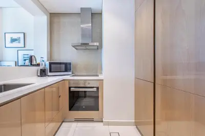 a kitchen with a sink and a microwave at DAMAC Towers by Paramount Hotels & Resorts Dubai in Dubai