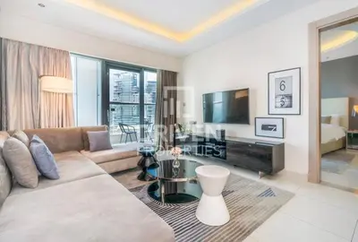 a living room with a couch and a table at DAMAC Towers by Paramount Hotels & Resorts Dubai in Dubai