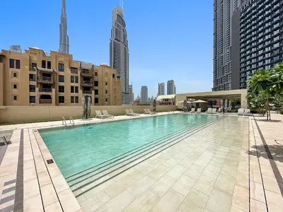 a large swimming pool on a building with tall buildings at Luxurious 1-Bedroom Apartment in Dubai