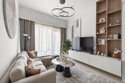 a living room with a couch and a table at Luxurious 1-Bedroom Apartment in Dubai