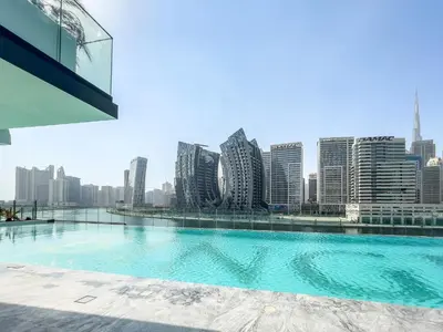 a swimming pool with a city skyline in the background at Elegant 1-Bedroom Apartment in Dubai
