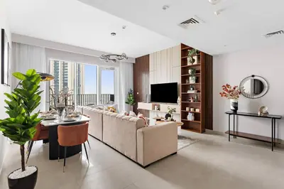 a living room with a couch and a table at Chic 2BR Stay at Creek Horizon with Pool, Gym and Prime Dubai Location in Dubai