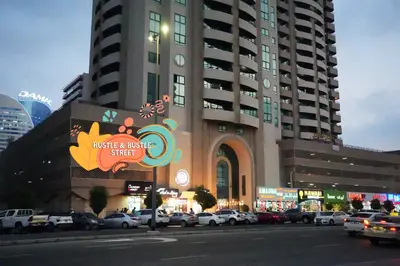 a large building with cars parked in a parking lot at The Hive Partition Room in Tecom Near Metro in Dubai