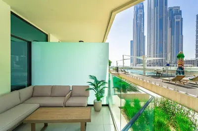 a living room with a couch and a view of a city at Urban Oasis by Missoni Studio in Dubai
