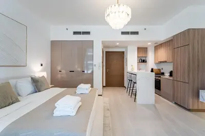 a living room with a bed and a kitchen at Urban Oasis by Missoni Studio in Dubai
