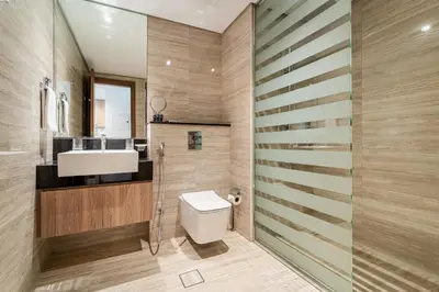 a bathroom with a white toilet and a sink at Urban Oasis by Missoni Studio in Dubai