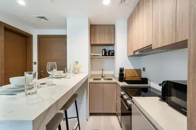 a kitchen with a counter with glasses on it at Urban Oasis by Missoni Studio in Dubai
