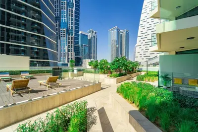 a patio in a city with tall buildings at Urban Oasis by Missoni Studio in Dubai