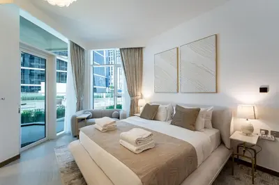 a bedroom with a large bed with towels on it at Urban Oasis by Missoni Studio in Dubai