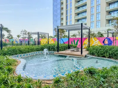 a small pool with a fountain in a park at Stylish 1-Bedroom in Prime Business Bay Aykon C in Dubai