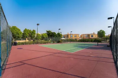 a tennis court with a net at Luxury Villa in Ranches 1, on Pool and Park in Dubai