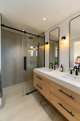 a bathroom with two sinks and a shower at Luxury Villa in Ranches 1, on Pool and Park in Dubai