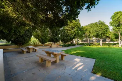 a group of benches sitting in a park at Luxury Villa in Ranches 1, on Pool and Park in Dubai