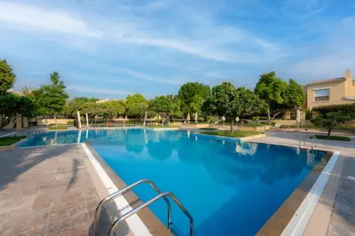 a large swimming pool with blue water at Luxury Villa in Ranches 1, on Pool and Park in Dubai