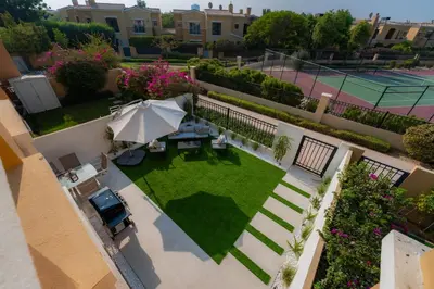 an aerial view of a tennis court with an umbrella at Luxury Villa in Ranches 1, on Pool and Park in Dubai