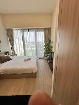 a bedroom with a bed and a large window at Cozy Retreat, Relax and Explore in Dubai