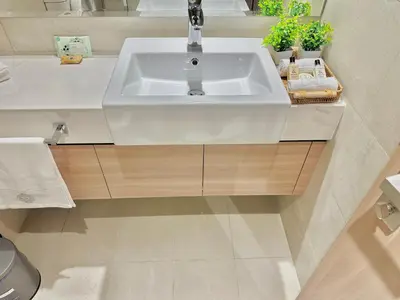 a white sink in a bathroom with plants at Cozy Retreat, Relax and Explore in Dubai