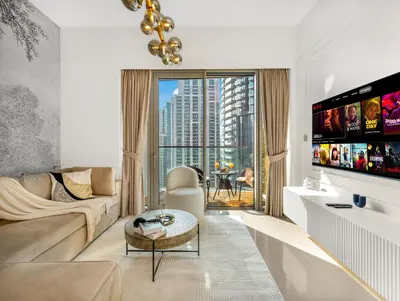 a living room with a couch and a tv at SmartStay at Grande Signature - Downtown Dubai City Views - Brand New Luxury Apartments in Dubai