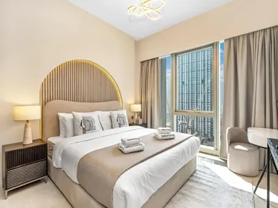 a bedroom with a large bed and a large window at SmartStay at Grande Signature - Downtown Dubai City Views - Brand New Luxury Apartments in Dubai