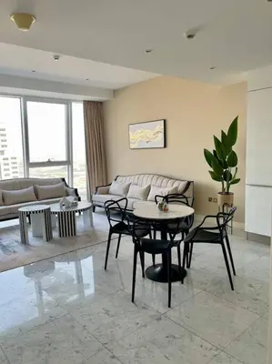 a living room with a couch and a table and chairs at 1BDR-furnished apartment, Business Bay, CANAL VIEW in Dubai