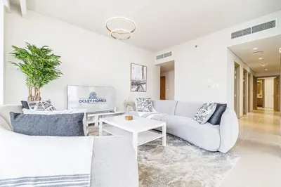 a living room with two couches and a table at Modern Home on 33rd Floor in Dubai Creek in Dubai