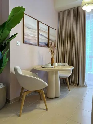 a living room with a table and a chair at Naseem - Elegant Coastal Retreat with Stunning Marina Views in Dubai