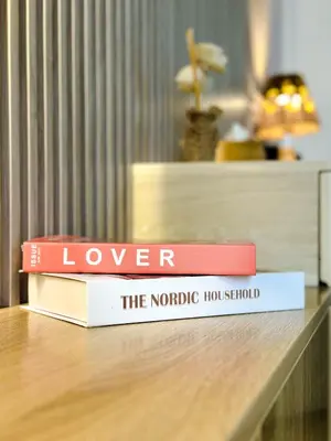 two books sitting on top of a table at Naseem - Elegant Coastal Retreat with Stunning Marina Views in Dubai