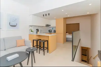 a living room with a couch and a table at AWS Holiday Homes - Tranquil Stay at the Palm in Dubai