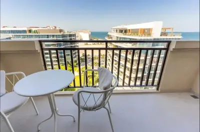 a balcony with a table and chairs and the ocean at AWS Holiday Homes - Tranquil Stay at the Palm in Dubai