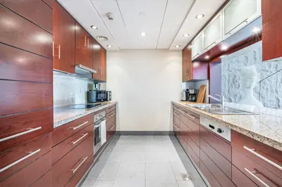 a large kitchen with wooden cabinets and appliances at Premium Home with Panoramic Burj Khalifa Views in Dubai