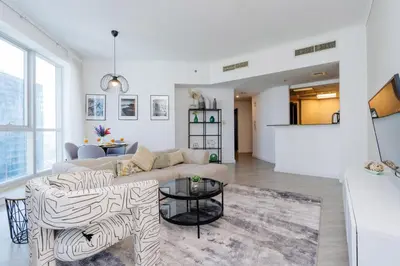 a living room with a couch and a table at Stunning Interior in an deal Location in Dubai