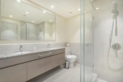 a bathroom with a sink and a toilet and a shower at Casa Nomad - Full Burj Khalifa & Fountain View at Luxury 4 Bed in Dubai