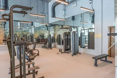 a gym with rows of exercise bikes and treadmills at Casa Nomad - Full Burj Khalifa & Fountain View at Luxury 4 Bed in Dubai