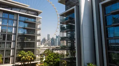 a view of the london eye from between two buildings at Bluewaters Island - Luxury 2BR with Ain View by TLRE Holiday Homes in Dubai
