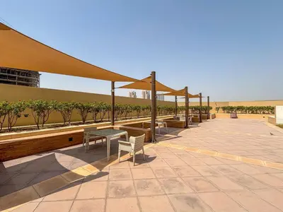 a pavilion with a table and chairs on a patio at Frank Porter - Damac Ghalia in Dubai
