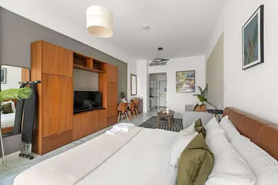 a living room with a large bed and a television at Silkhaus Ocean View in Palm Views Holiday Vibes in Dubai