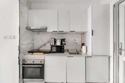 a white kitchen with a sink and a microwave at Silkhaus Ocean View in Palm Views Holiday Vibes in Dubai