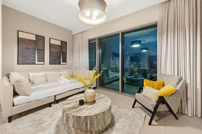 a living room with a couch and a table at 4BR with Spacious Balcony & Stunning Burj Khalifa Views in Dubai