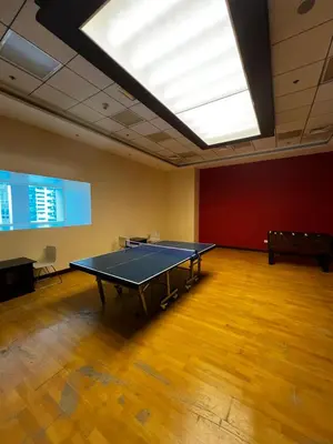 a ping pong table in a room with a skylight at Elite Residence Appartment 4007 in Dubai