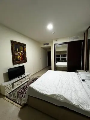 a bedroom with a large bed and a flat screen tv at Elite Residence Appartment 4007 in Dubai