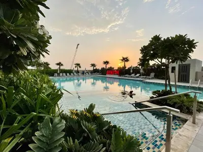 a large swimming pool with people in the water at Appartement spacieux de luxe à 5mn du Burj Khalifa in Dubai